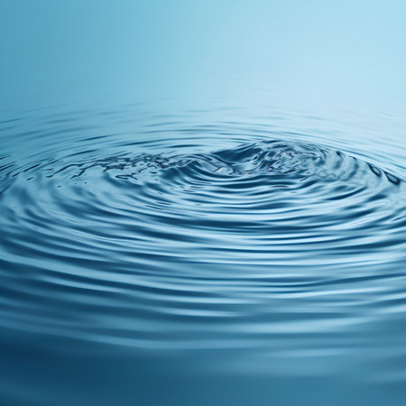 Water ripples with ripples and waves on a blue background.の素材