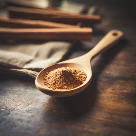 Cinnamon powder in a wooden spoon on a wooden table. Selective focus.の素材