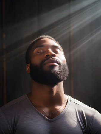 Portrait of a young african american man with beard on dark backgroundの素材