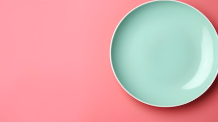 Empty green plate on pink background, top view, copy space.の素材
