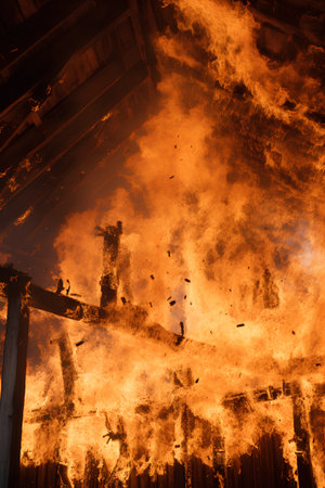 Burning wooden house. Fire in the house. Burned house.の素材