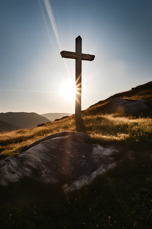 Cross on the hillside at sunset. Cross on the peak of the mountainの素材