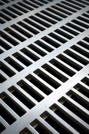 Closeup of a metal grate. Abstract background and texture for design.の素材
