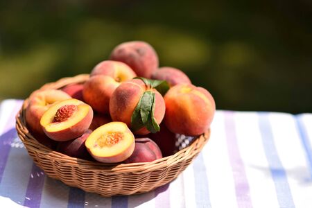Basket full of peaches on stripes fabricの写真素材
