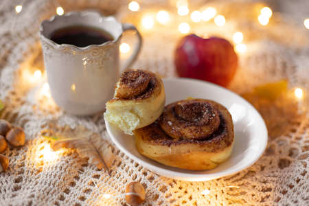 Homemade cinnamon rolls with hot tea, styling with autumn or fall atmosphereの写真素材