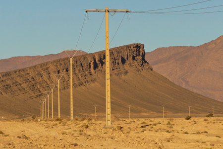 Electricity post in the middle of the desert with mountains in the background. Morocco, Tata valley rock formations. province of Souss Massaの写真素材