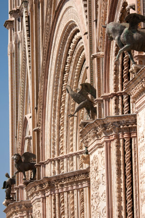 Detail of the facade of The Cathedral of Orvieto, one of the greatest artistic achievements of the Italian late Middle Ages with our Gothic-style facadeの写真素材