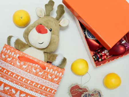 Christmas toy reindeer as a gift on a white background.の写真素材