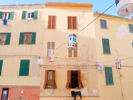 View of typical Italian houses with shutters. Alghero, Italy