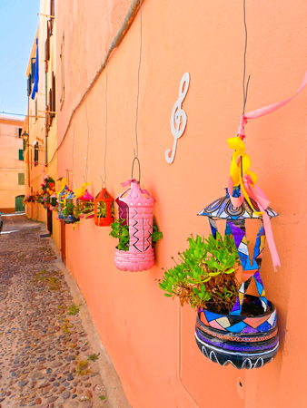 A narrow alley decorated with beautiful flowers in Alghero. Sardinia.の写真素材