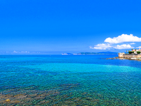 View of the sea and a fragment of Alghero defensive walls. Sardinia.