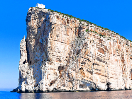 A beautiful view of the cliffs with the lighthouse Capo Caccia. Sardinia.の写真素材