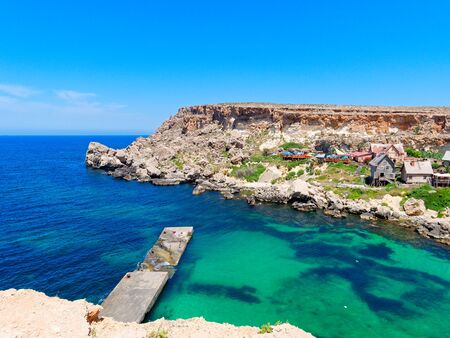 Beautiful Anchor Bay with azure and clear water. Malta.の写真素材
