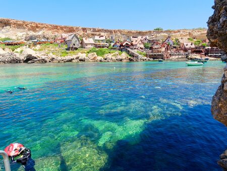 beautiful azure water and the coast at Anchor Bay in Malta.の写真素材