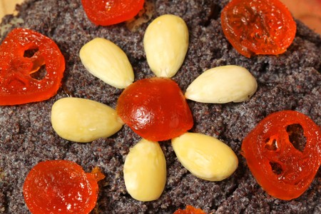 Traditional Polish Christmas poppy seed dessert 'makowki' with almonds and dried kumquatsの写真素材