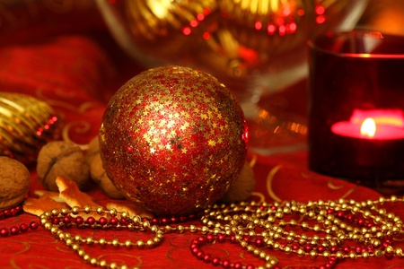 Beautiful golden and red Christmas decoration of table with glassball and candleの写真素材