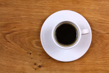 Top view on cup of coffee espresso on desk boardの写真素材