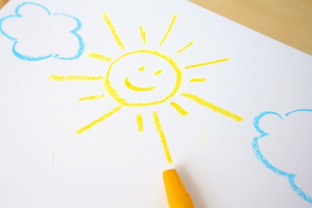 Cute childish drawing by wax crayons  Sun and cloudsの写真素材