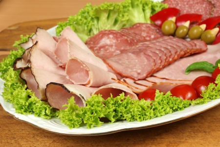 Party banquet plate with cold cuts of polish ham and sausage. Traditional polish smoked meat の写真素材
