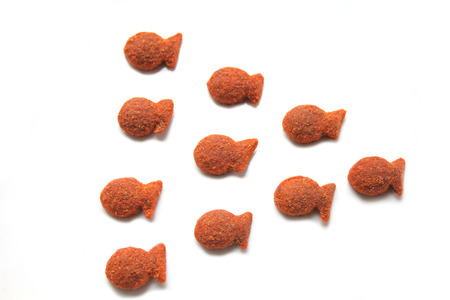 Cats dry food - fish shapes on white backgroundの写真素材