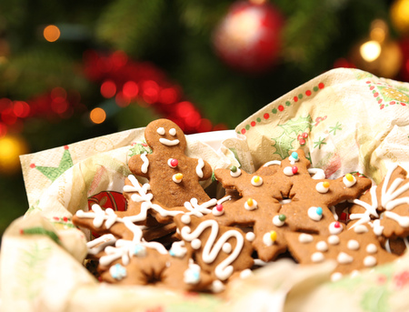 Christmas gingerbread cookies in front of Christmas tree