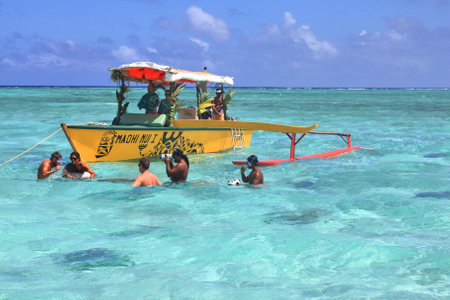 BORA BORA, FRENCH POLYNESIA - SEPTEMBER 28, 2012 : People snorkel and play with stingrays and sharks. Stingray feeding is a popular attraction in Bora Boraのeditorial素材