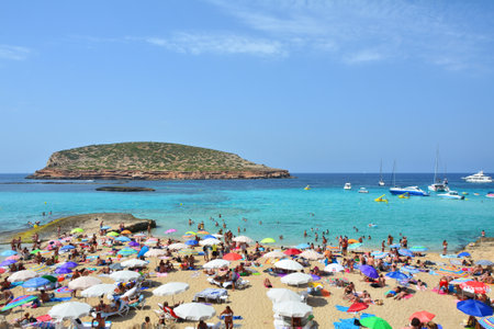 IBIZA, SPAIN - JULY 13, 2017: Tourists relax on Cala Comte, famous beach of Ibiza islandのeditorial素材