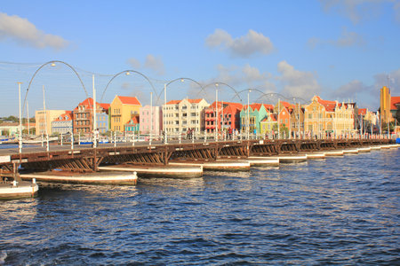 WILLEMSTAD, CURACAO - FEBRUARY 12, 2014: Pontoon bridge and waterfront with harbour and colorful houses in Willemstad, Caribbean. The city center is UNESCO World Heritage Site.のeditorial素材