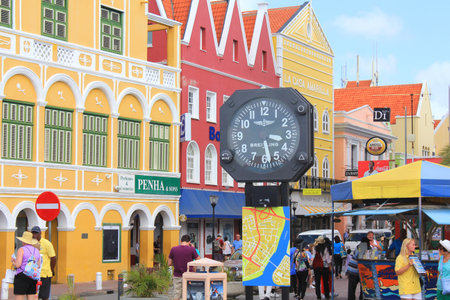 WILLEMSTAD, CURACAO - FEBRUARY 11, 2014: Colorful waterfront buildings and a clock in Willemstad historic district Punda on Curacao island. The city center is UNESCO World Heritage Site.のeditorial素材