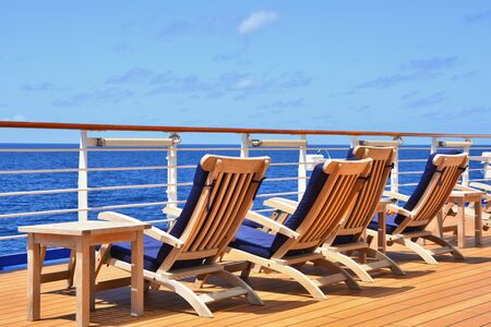 Sunbeds on open deck of cruise ship with the ocean view.の写真素材