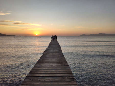 Wooden sea promenade at Playa de Muro on Mallorca, Spain. Sunrise at the beach.の写真素材