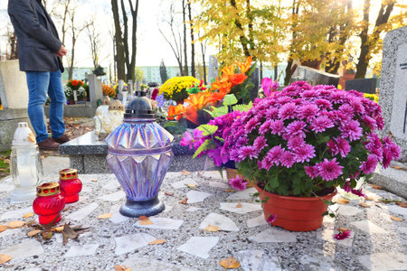 Flowers and candles on the grave at cemetery. All the Saints Day holiday on 1 November in Poland.の写真素材