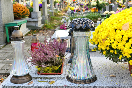 All the Saints Day holiday on 1 November in Poland. Flowers and candles on the grave at cemetery.の写真素材