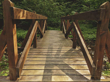 Wooden bridge over a small river.