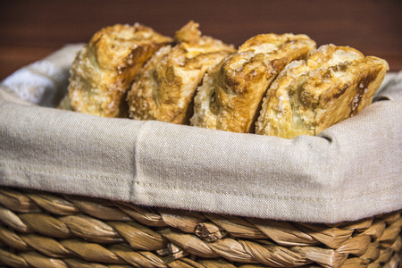 Baked goods displayed in a wooden basket with a wood background