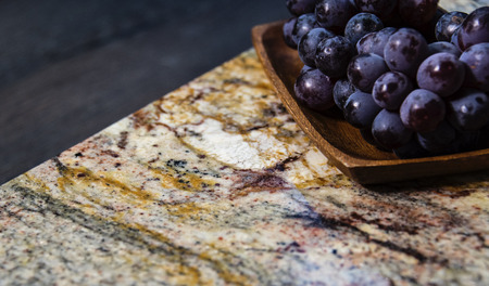 Fruit on surface. Granite worktop. Brown kitchen design.