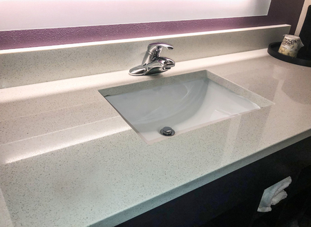 Bathroom sink with white marble countertop and grey silver fausetの写真素材