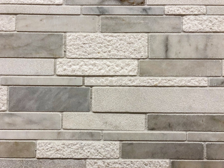Gray and white tiles of different sises and texture plased horizontal, can be used as wall tile and can be used as kitchen countertop backsplash tileの写真素材