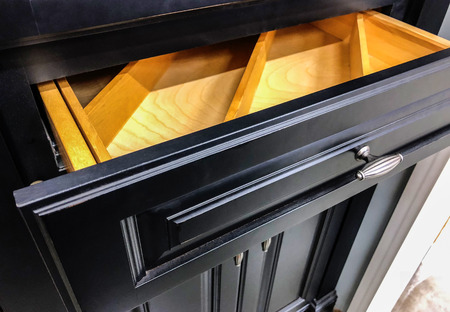 Black kitchen cabinet drawer and doors with door knobの写真素材