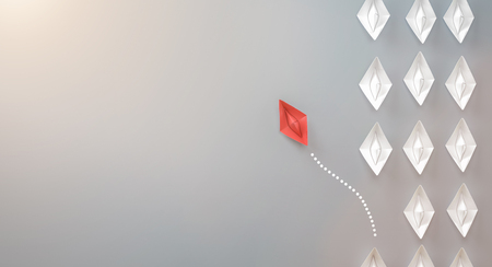 paper boat leadership concept - red paper boat leading the rowの写真素材