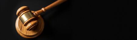 judge or auction Gavel on a wood block in courtroom, dark background