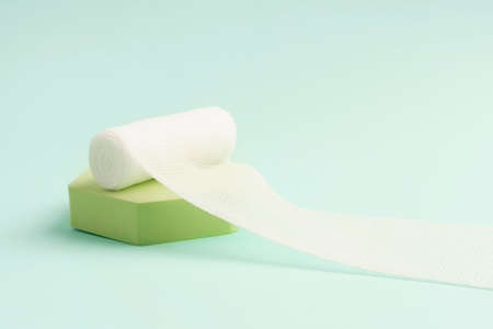 Close up view of single bandage on the green podium on lightの写真素材