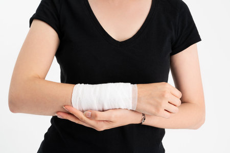 Young woman with gauze bandage wrapped around her injured hand.
