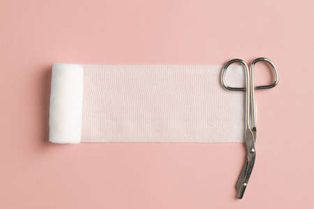 Close up view of single bandage and specialistic scissors on