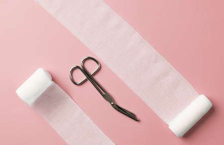 Medical bandages with scissors on the colorful background.の写真素材