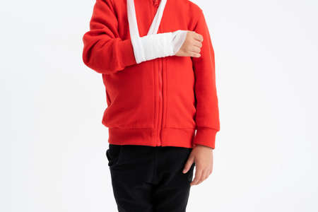Little boy with broken arm in a cast after injury. Arm splint for