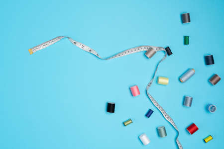 A lot of diffrent sewing accesories scattered all over blueの写真素材