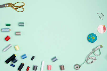 A lot of colorful spools of thread arranged on the green