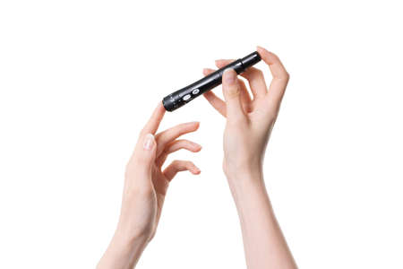 Close up picture of hands with glucose metter and lancete pen. This person will measure blood sugar...