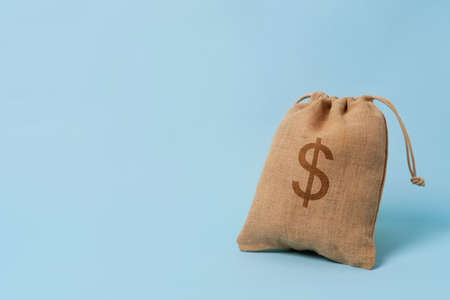 Full of cash dollar money bag on the blue background.の写真素材